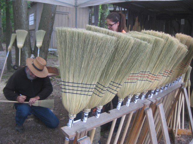Some little kids asked this broom maker to sign their brooms.
